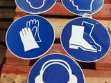 four blue and white signs on a pallet in a warehouse