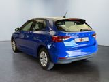 the rear end of a blue car parked in a showroom