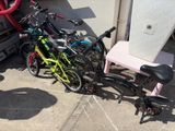 many bikes that are parked next to each other on the sidewalk