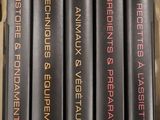 four books in a wooden box on top of a table