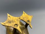 brass statue of a cat with a star on its head