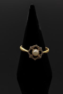 une bague en or avec une perle au centre