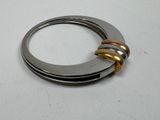 a close up of a metal ring with two gold rings on top of it