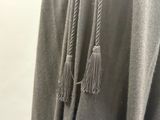 two tassels hanging from the back of a coat