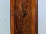 a tall wooden cabinet with a clock on top of it