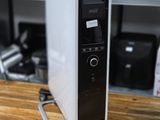 a black and white air purifier sitting on a wooden table