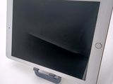 a tablet that is sitting on a stand on a table