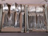 a lot of silverware in a box on the table
