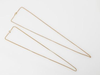 three gold chain necklaces on a white background