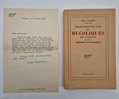 an old book sitting on top of a table next to a piece of paper