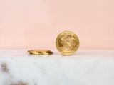 a gold coin sitting on top of a marble counter