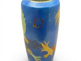 a blue vase with a gold fish design on it