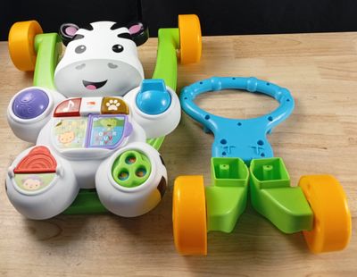 a toy car and a toy cow on a table