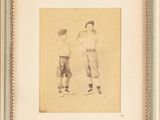 an old picture of two baseball players standing next to each other