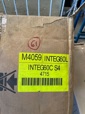 a cardboard box with a sticker on it sitting on a carton