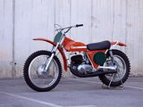 a red dirt bike parked in a parking lot
