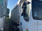 two trucks that are parked next to each other