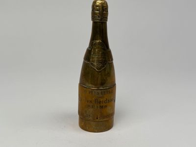an antique brass bottle of champagne on a white background