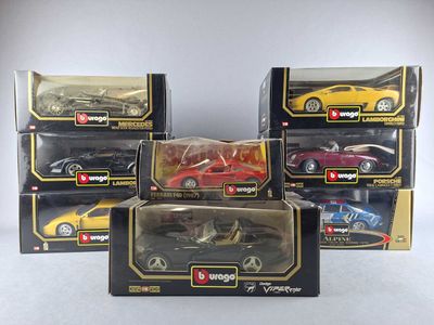 six toy cars are in a box on a white surface