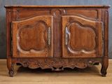 a wooden cabinet with two doors on the top of it