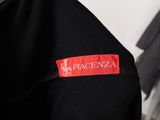a close up of a black jacket with a red label on it