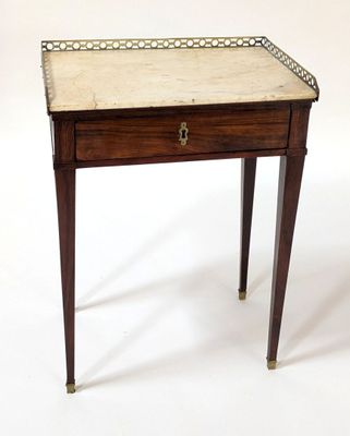a small wooden table with a marble top on it