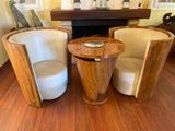 two chairs and a table in a room with a fire place