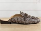 the brown and white slippers are on a wooden table