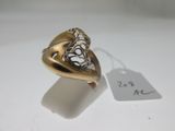 a close up of a ring with a tag on a table