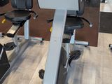 a gym room with a row of stationary exercise bikes