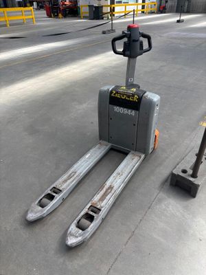 a forklift that is sitting on the ground next to a pole