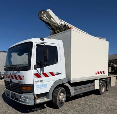 a white truck with a crane on the back of it