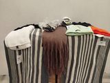 a pile of clothes sitting on top of a wooden crate