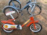 two bikes that are sitting in the grass