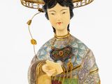an image of a figurine of a woman with a hat on her head