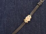 a close up of a watch sitting on top of a blue cloth