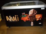 a picture of a small ice cream machine with chocolates on it