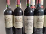 six bottles of red wine are lined up in a row