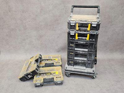 two tools are sitting on a cart next to a stack of boxes