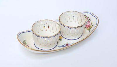 two cups and saucers sitting on a plate