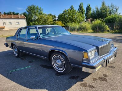 an image of a blue station wagon parked in a parking lot