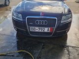 a car that is parked in a lot with a hose attached to it