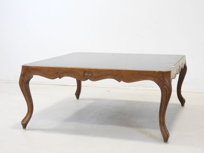 an image of a wooden table with a glass top on a white floor