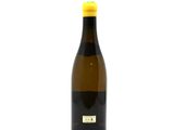 a bottle of wine that is sitting on a white surface