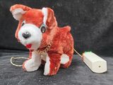 a red and white dog with a gold chain around its neck