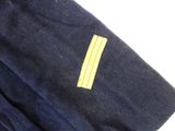 a close up of a navy uniform with a yellow stripe on it