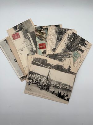 a pile of old postcards sitting on top of a table