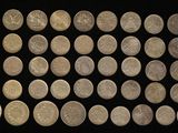 an image of a group of silver coins on a black surface