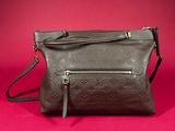 a close up of a brown purse on a red background