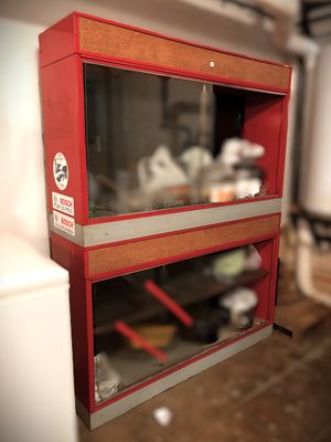 a red cabinet with two glass shelves on the wall